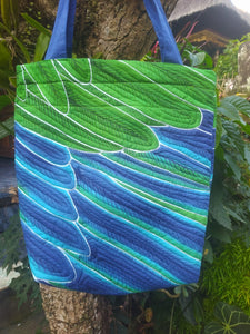 Green and blue feathers of the male Eclectus parrot have been artfully batiked by hand on this shoulder bag
