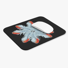 The pinwheel of African grey parrot feathers is stunningly set against a black background. Besides the grey feather color, one side of the tips are red. A wireless mouse is on the mousepad to give an idea of the mouse pad's size.