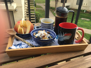 The African Grey Feather Mug is set on a breakfast tray along with bowls of granola, apple slices, and juice.  Photo sent by Gwen R., a very happy customer!