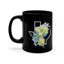 Black mug with a handpainted batik design (that is printed on the mug) of a bouquet of yellow roses with greenery set against the outline of the Texas border. The two sides of the mug have the design so it's visible whether you are left or right-handed.\