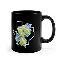 Black mug with a handpainted batik design (that is printed on the mug) of a bouquet of yellow roses with greenery set against the outline of the Texas border. The two sides of the mug have the design so it's visible whether you are right or left-handed.