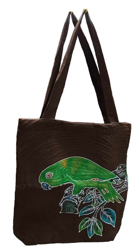 A Yellow-naped Amazon parrot is perched on a broken leafy branch. The design is batiked and painted by hand. The background color is dark brown. A lovely shoulder bag for the Amazon lover.