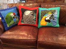 Blue & Gold macaw batik pillow cover stuffed and on a couch