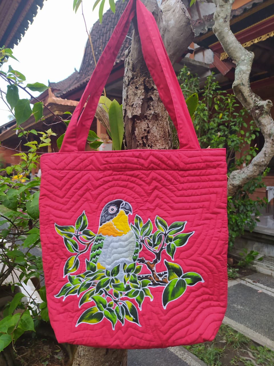 A lovely hand-painted batik tote-style bag with a curious Black-headed Caique set amongst tropical foliage.