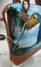 Oblique view of the hand-tooled, hand-painted Blue & Gold macaw at the beach leather bag.