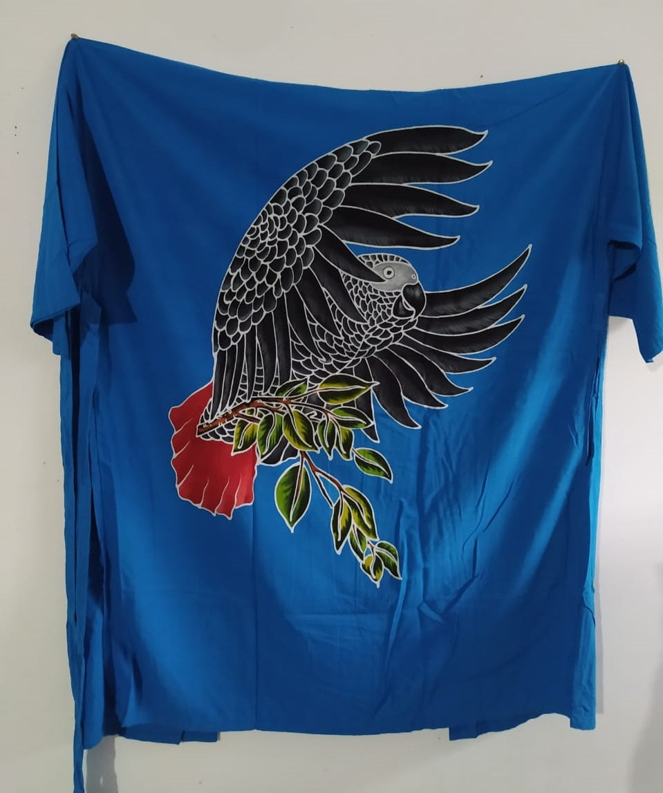 Handpainted batik kimono of a flying African Grey parrot, carrying a short twig with leaves in its feet.
