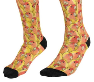 Unisex socks of a repeating pattern of the heads and upper bodies of lutino peachface lovebirds. Reinforced black heels and toes.