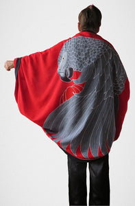African Grey parrot hand-painted batik sarong worn as a jacket - back view with red background