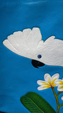 Close-up view of the Umbrella cockatoo's head which has been hand-tooled and handpainted onto a leather tote-style bag